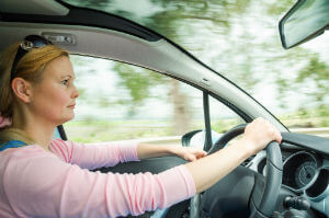 woman driving car with one hand