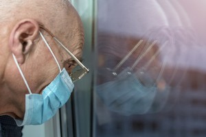 elderly man looking out window