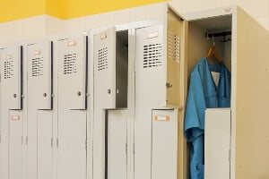 image of a locker with a nurse's scrubs hanging in it